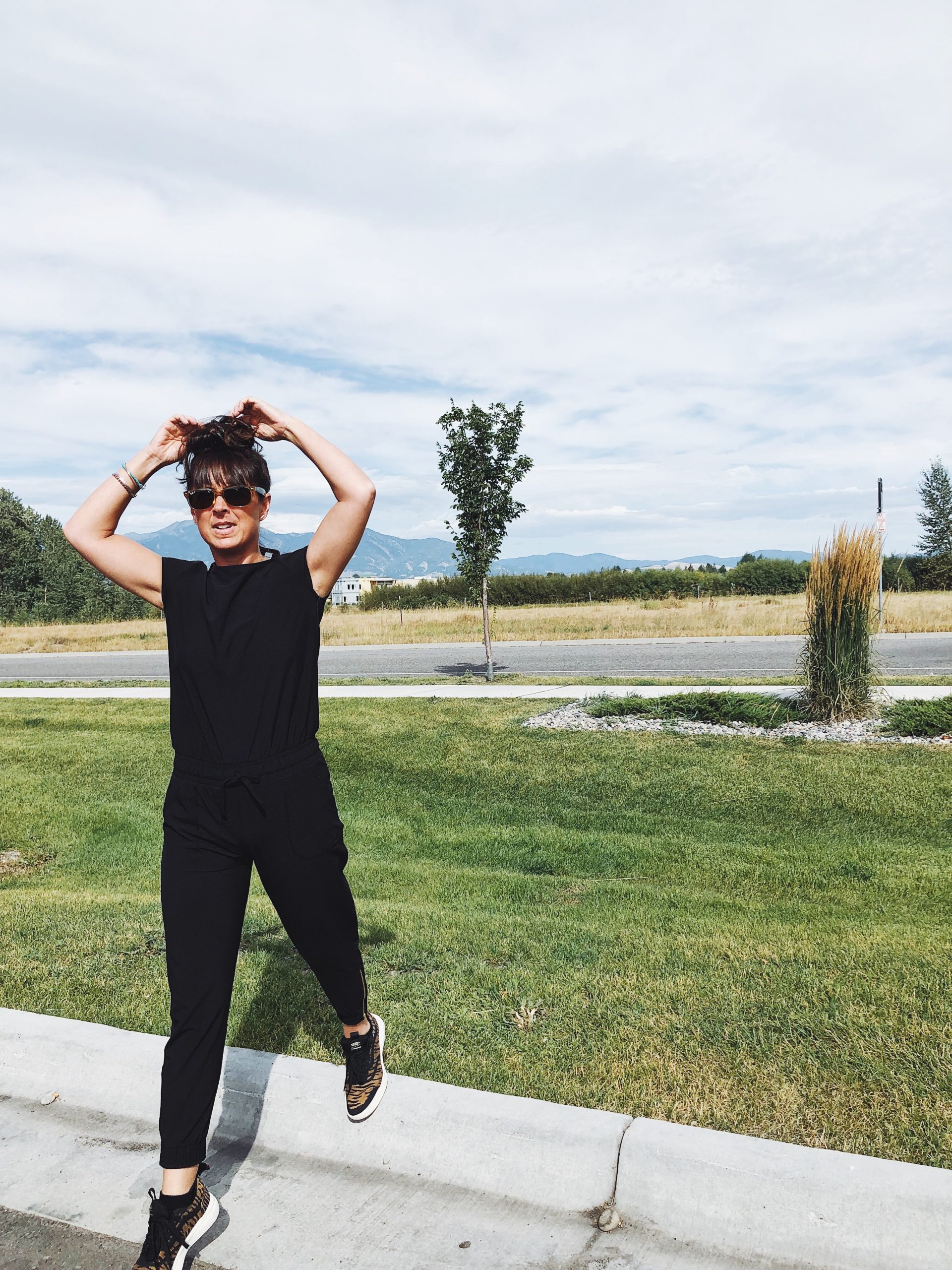 woman stepping off curb wearing Albionfit jumper in black in Bozeman montana